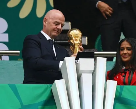 Gianni Infantino holds the World Cup trophy alongside actor and Fifa World Cup 2026 ambassador Salma Hayek before the opening game in Mexico City