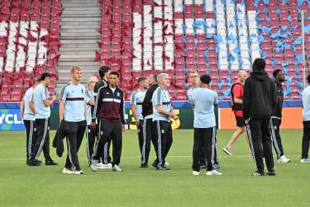 Players and staff of Aston Villa on the pitch at Stadion Salzburg.